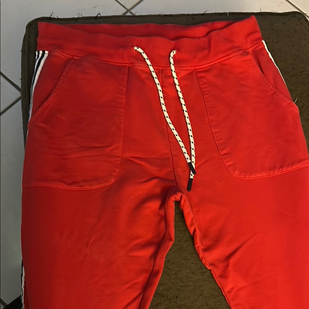 Psycho Bunny Vibrant Red Joggers with white and black stripes on side.